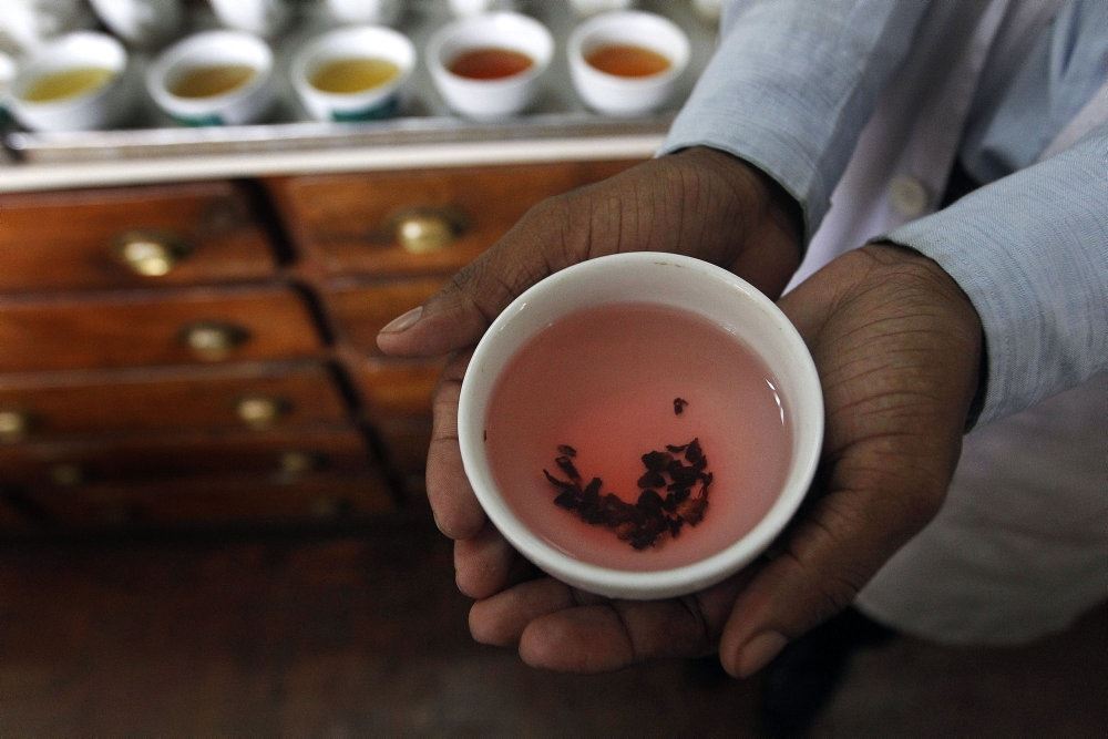 Billede af en kop te holdt af en hånd