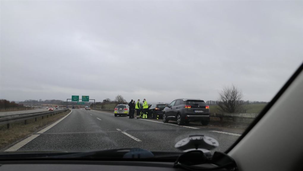 Billede fra motorvejen. Man kan se en smadret bil og flere betjente og læger der står ved ulykken.