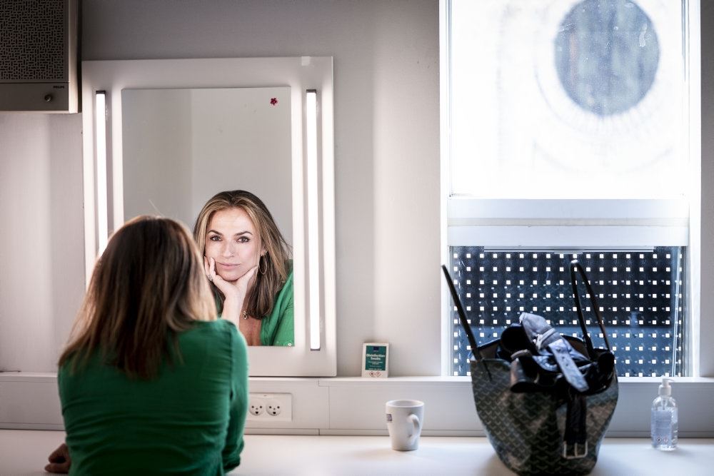 En kvinde kigger på sig selv i et makeup-spejl