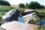En lastbil med olie er væltet i en kanal på Djursland