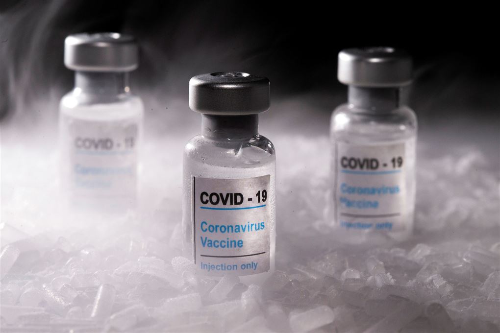 Tre små flasker med Covid-19 vaccine skrevet på