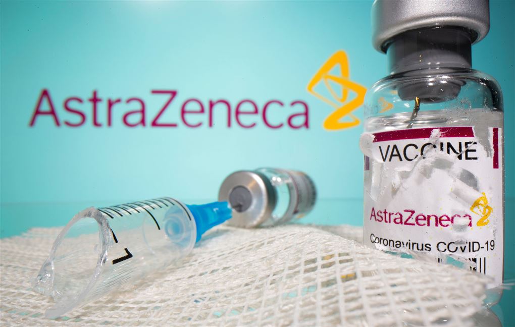 vaccineglas og kanyler på bord foran astra-zeneca-logo