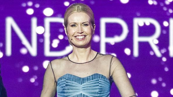 Tina Müller under Melodi Grand Prix 2021 med en lyseblå gallakjole og et stort smil. 
