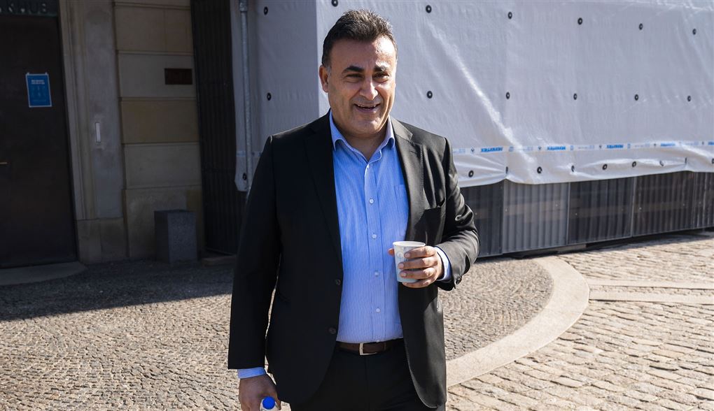 En smilende Naser Khader med en kaffekop i hånden
