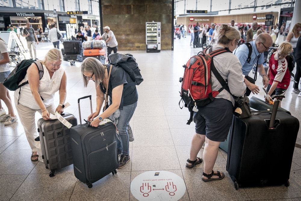 folk står med bagage i lufthavn