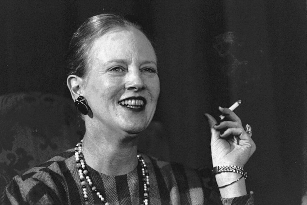 Dronning Margrethe smiler og ryger
