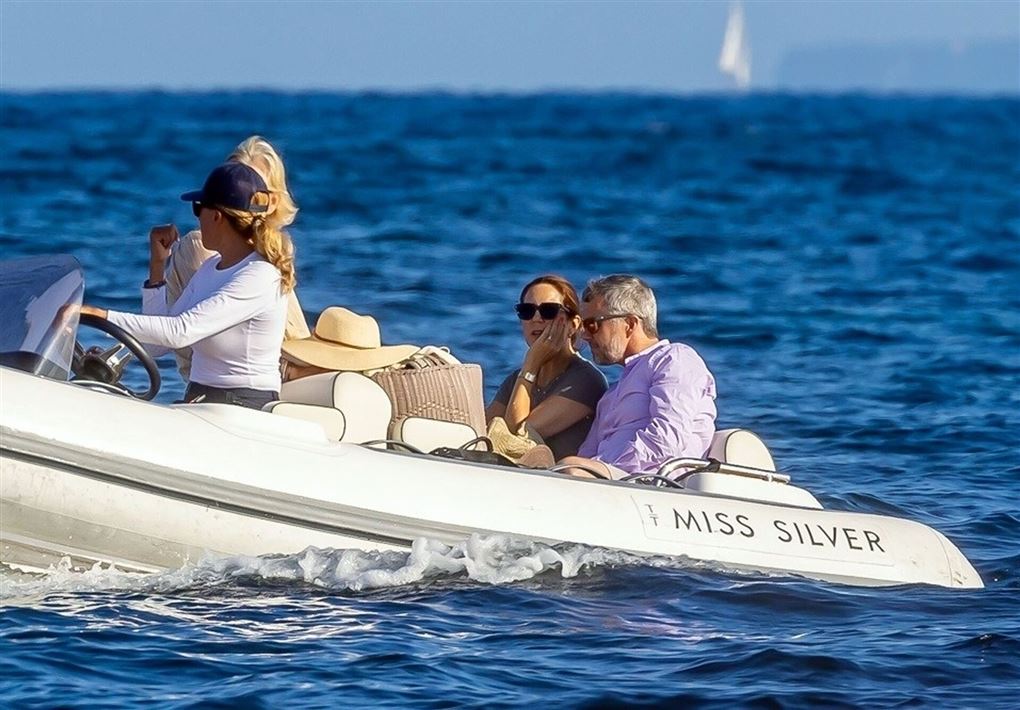 Kronprinsparret sidder ved siden af hinanden i en speedbåd.
