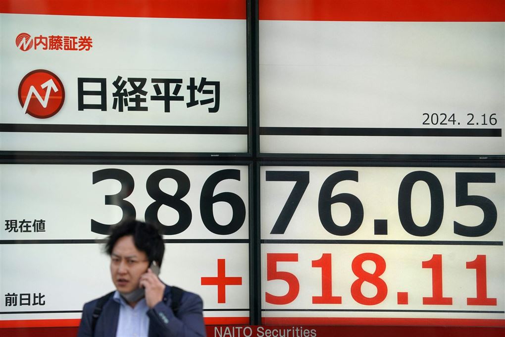 En japaner taler telefon foran et børs-skilt