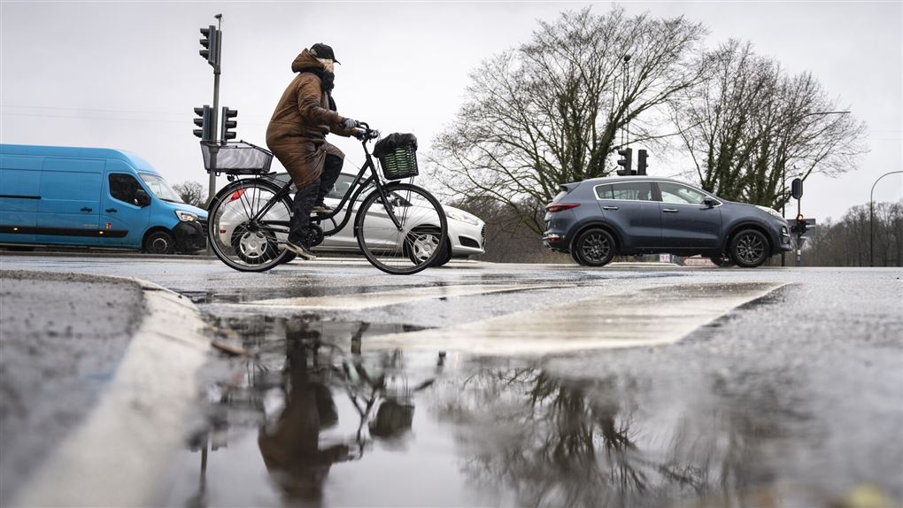 cyklist og biler på våd vej