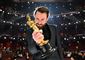 en mand med en Oscar-statuette
